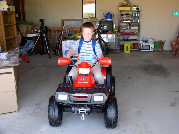 Tom sits on his birthday present