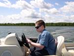 Tom driving Mac and Joanie's pontoon boat.